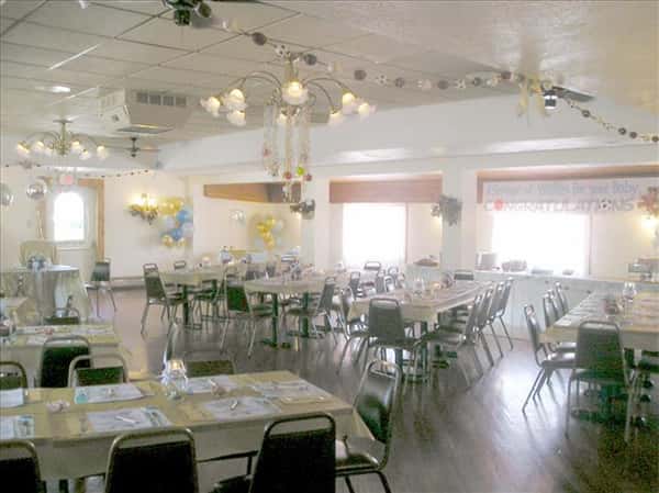 Event room decorated for a baby shower with colorful tables set for a party