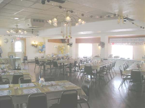 Event room decorated for a baby shower with colorful tables set for a party