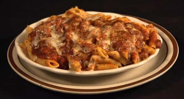 Plate of penne served with red sauce and melted cheese