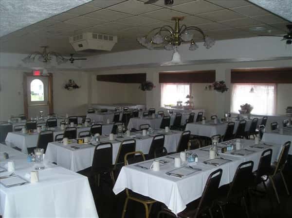Dining hall with tables set in white linen