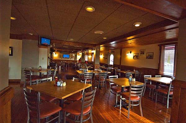 Interior photo of the dining hall and two blue screens in the background
