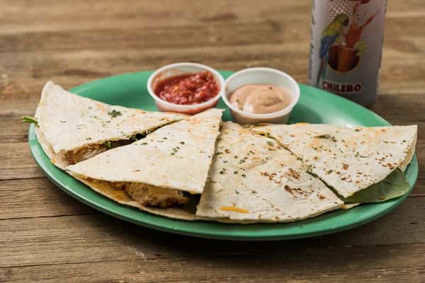 A quesadilla with a side of salsa and dipping sauce