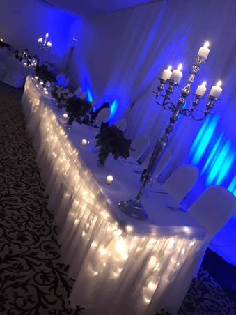 Wedding party table set up with glass wear and dishware with candles