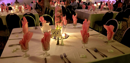 Table set up with table number, flowers, and candles