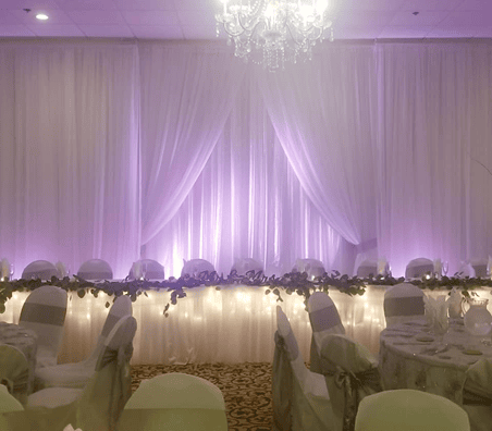 Venue lit up in lights and white drapes