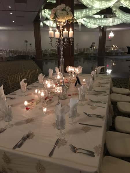 Wedding tables set up with glass wear and dish wear with candles