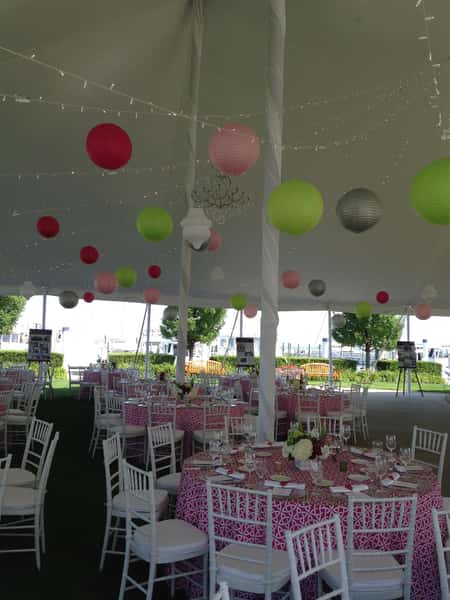 All wedding tables set up with white, link, and green lanterns hanging down