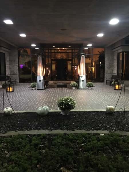Outside entrance of venue with flowers and tall candles