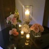 Candles surrounded by pink and white flowers