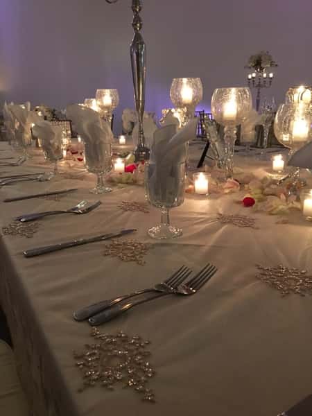 Wedding tables set up with glass wear and dish wear with candles