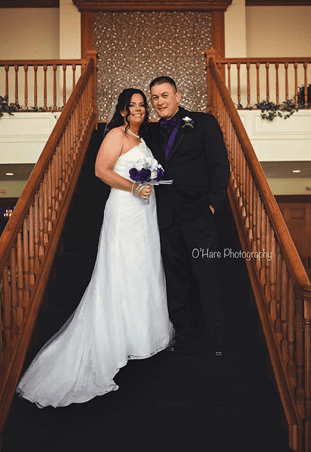 Married couple posing on staircase