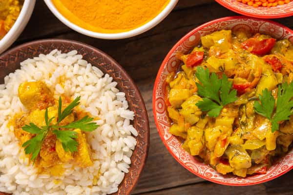 Indian curry served with white rice and fresh coriander