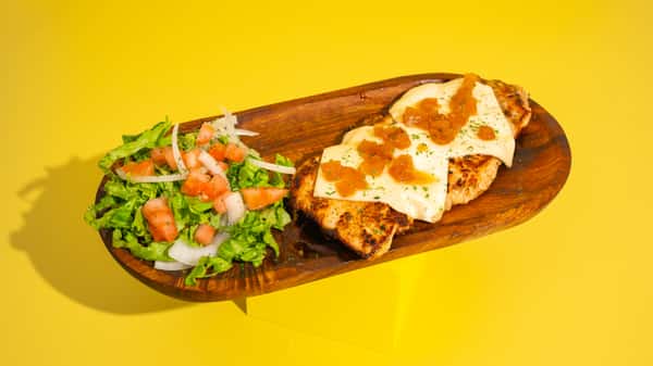 Juicy grilled chicken breast fillet with cheese and caramelized pineapple bits! Served with French fries and a traditional side salad.