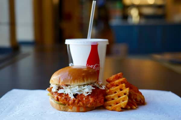 chicken sandwich with a drink and fries