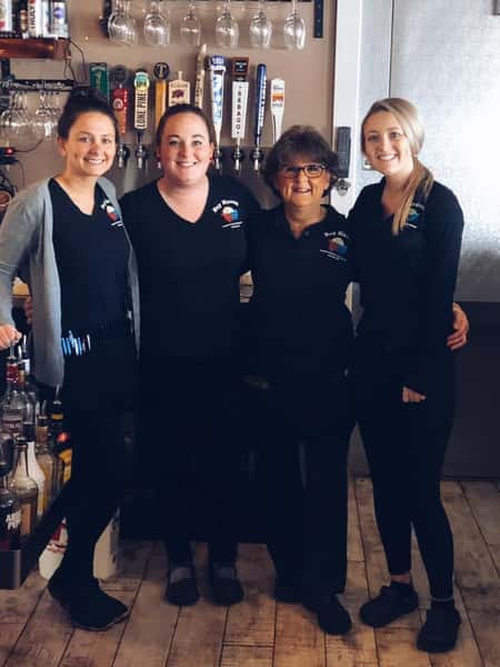 four women employees in the bar area