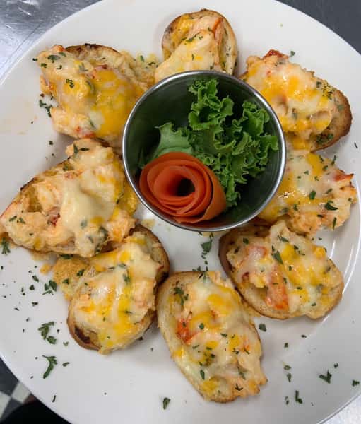 Lobster Bites, small pieces of lobster with cheese and garnish