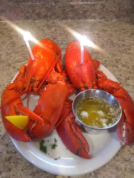 two lobsters with birthday candles in them