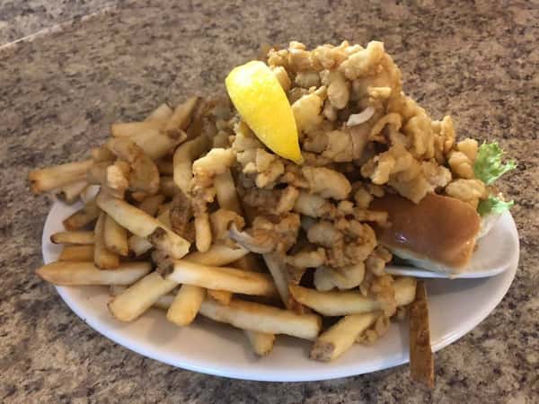 fried clam on a roll with a side of fries