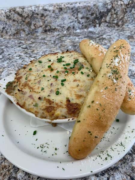 fried cheese dish with bread sticks