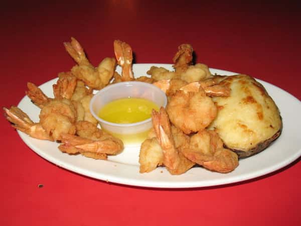 fried shrimp on a plate with butter sauce