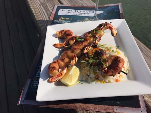grilled shrimp skewers with rice and slice of lemon