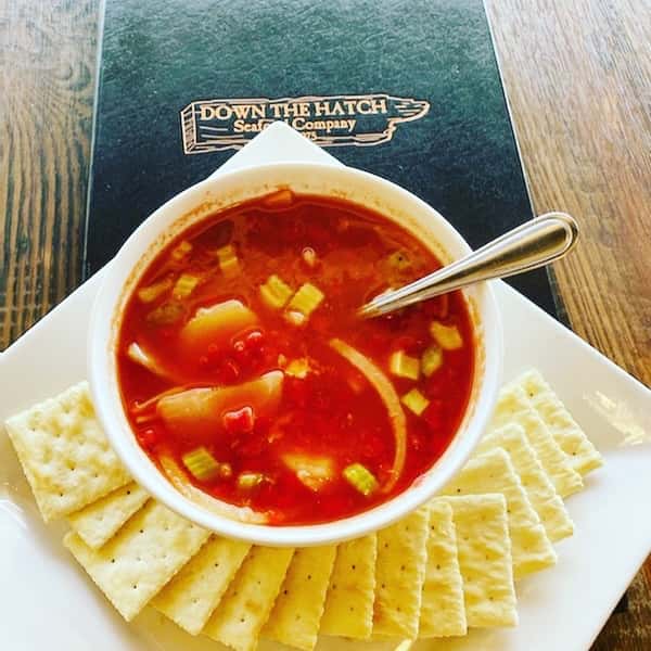 bowl of minestrone soup with crackers