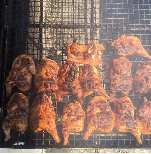 asssortment of grilled chicken on a smoke rack