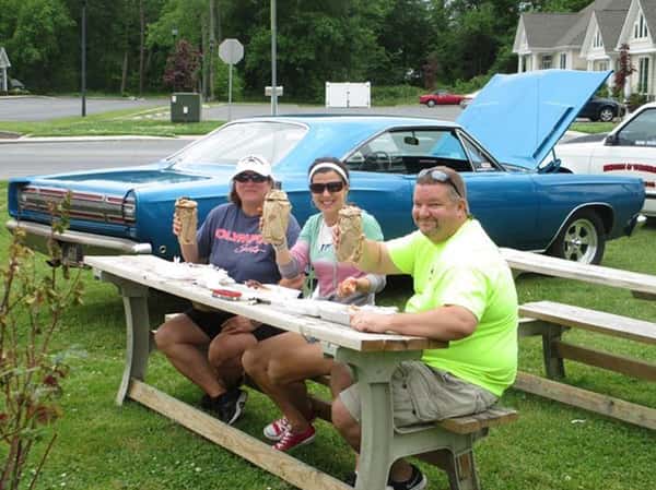 people sitting at picnic table eating bbq