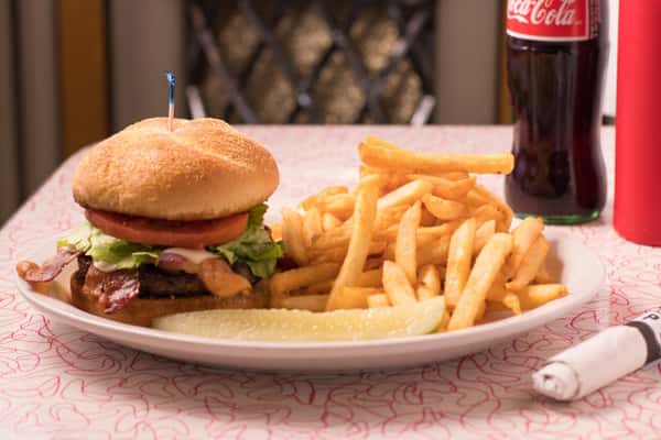 Hamburger with fries, and a Coca-Cola in a glass bottle