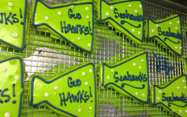 Light green covered cookies topped with dark green letters