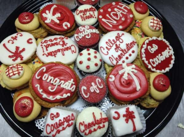 Several cookies topped with red and white decoration and letters