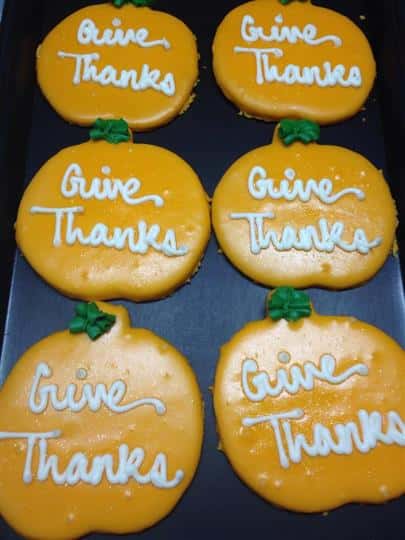 Yellow covered cookies with white letters
