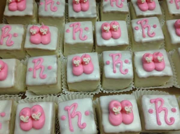 Mini cakes topped with white topping, and pink decoration