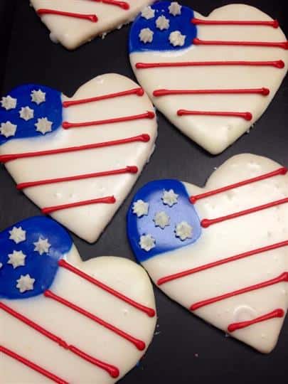 Covered white cookies in heart shape with USA flag decoration