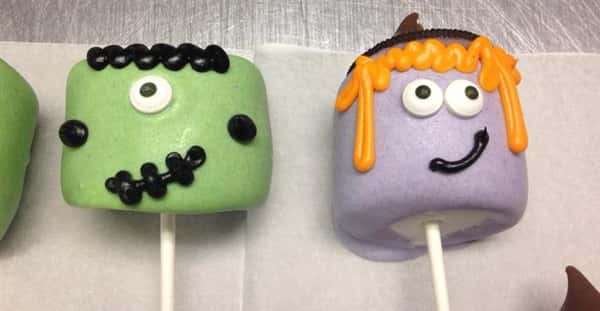 Green and violet cake pops with funny face decoration