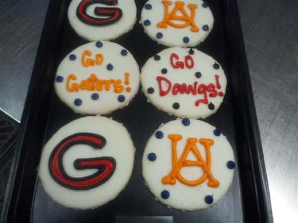 White covered cookies decorated with letters in several colors