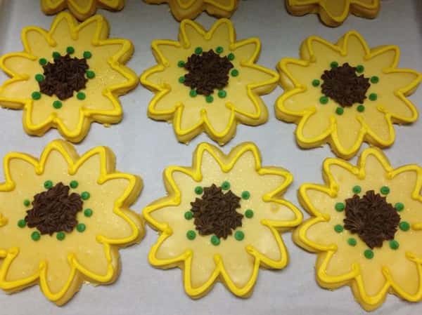 Yellow cookies in flower shapes topped with chocolate chips