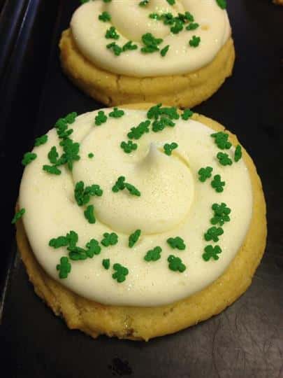 Cookie topped with white frosting and green decoration