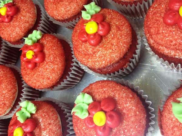 Cupcakes with chocolate fillings topped with red sugar flowers