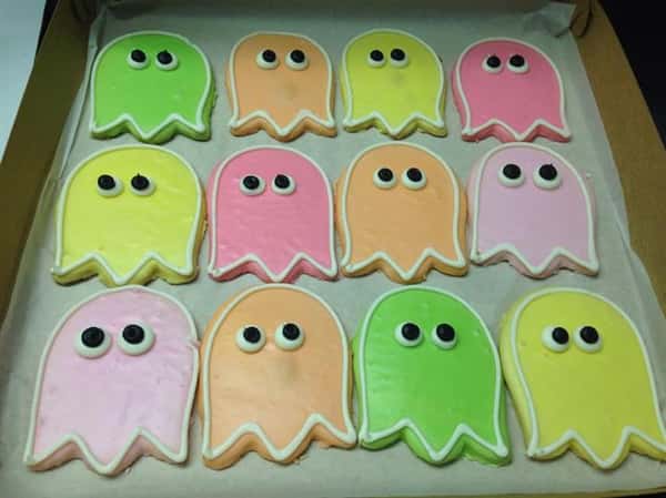 Covered cookies in several colors in the shape of ghost