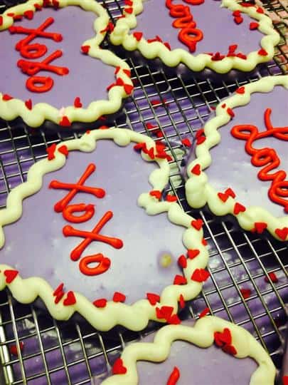 Violet covered heart cookies with red and white decoration