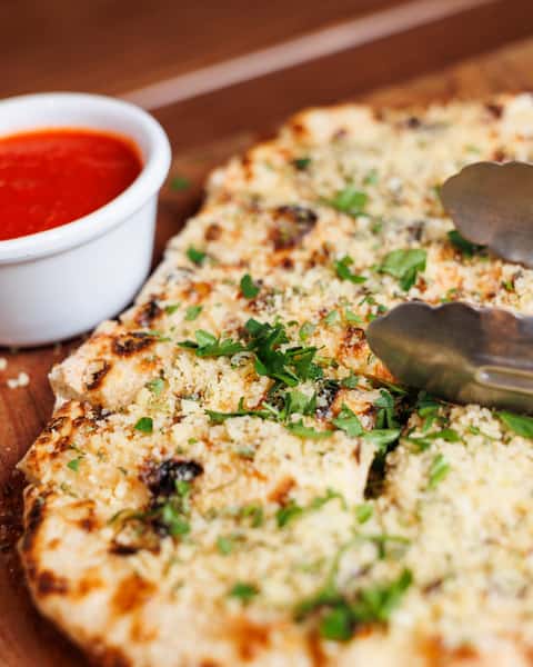 Surrender to the siren song of Antica Pizzeria & Market's Garlic Bites 🍕. Indulge in our signature blistered pizza dough smothered in butter, garlic, oregano, and our addictive bite dust. It's a flavor explosion! 😋 #AnticaPizzeria #GarlicBites #FoodieFave