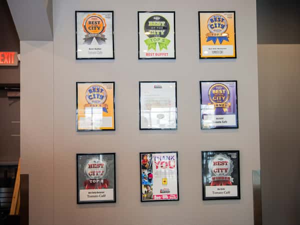Wall with awards won by Tomato Cafe
