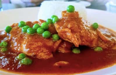 Entree with red sauce and green peas