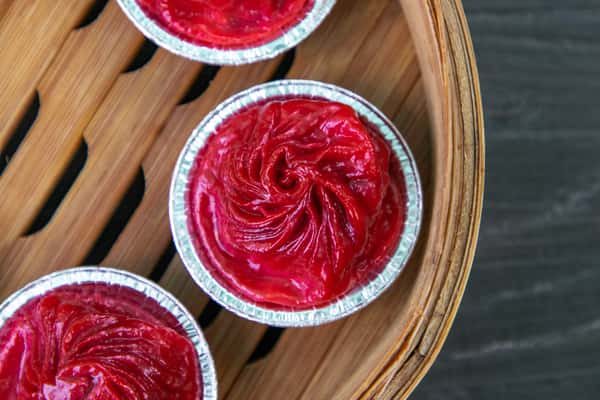 A red colored dish in a mini silver pie pan