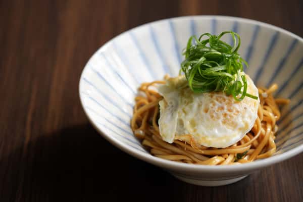 Scallion noodles topped with a fried egg
