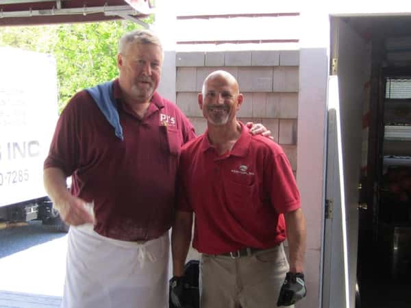 two men smiling posing for the camera