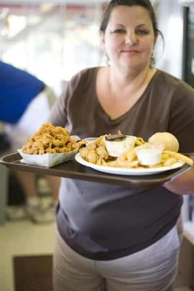 woman holding a tray of food