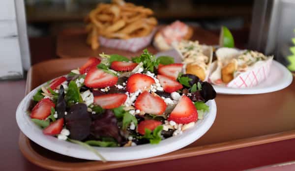 strawberry salad topped with feta cheese