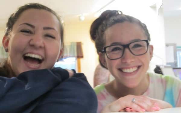 two girls smiling posing for the camera